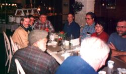 toward the foot of the table
